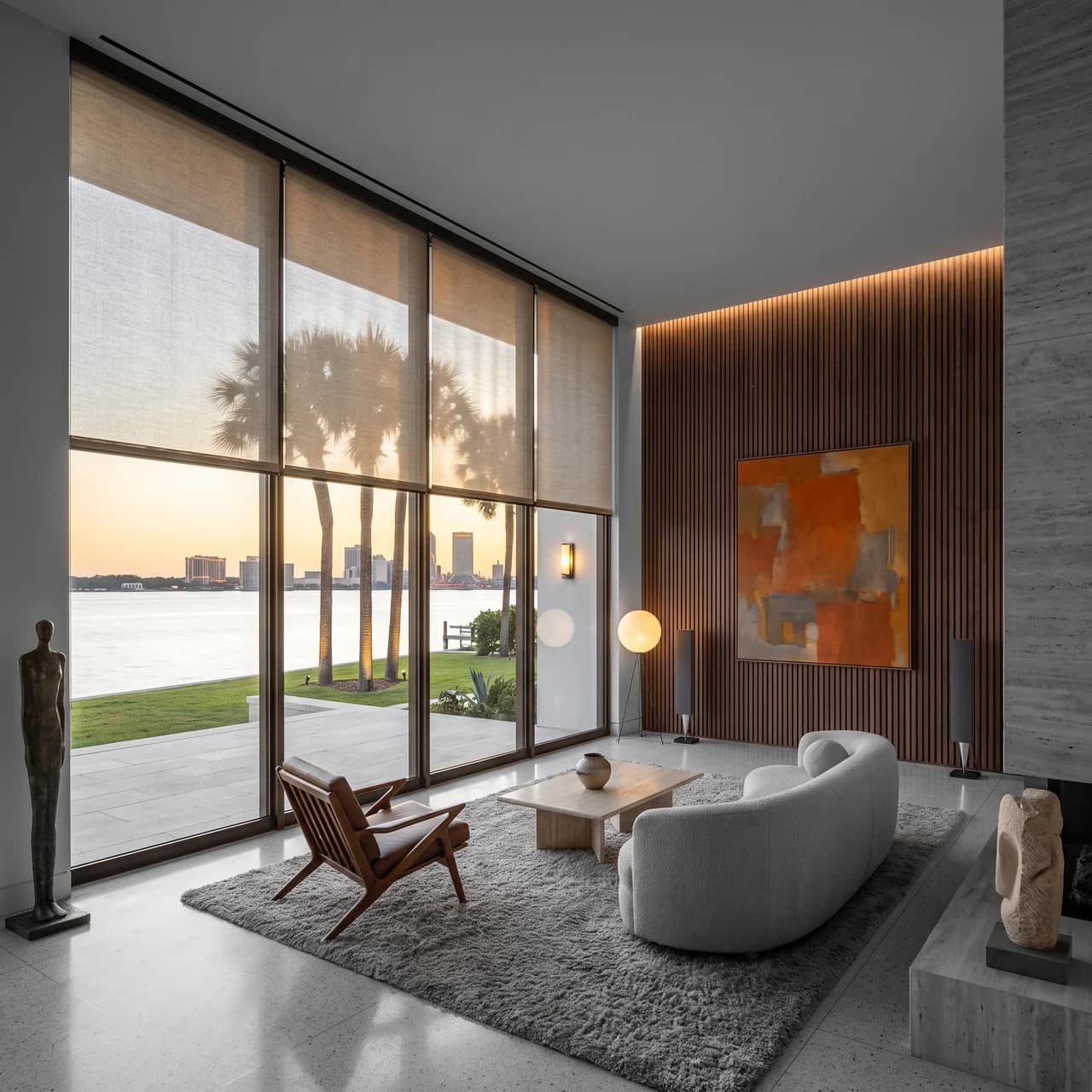 A Jacksonville living room with motorized solar shades lowered against the evening skyline.