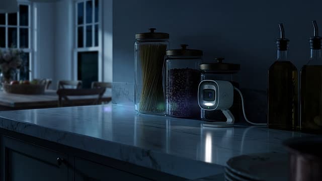 The same kitchen at night, the camera quietly illuminated